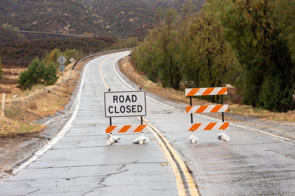 Road blocked off by a "Road Closed" sign and barriers.