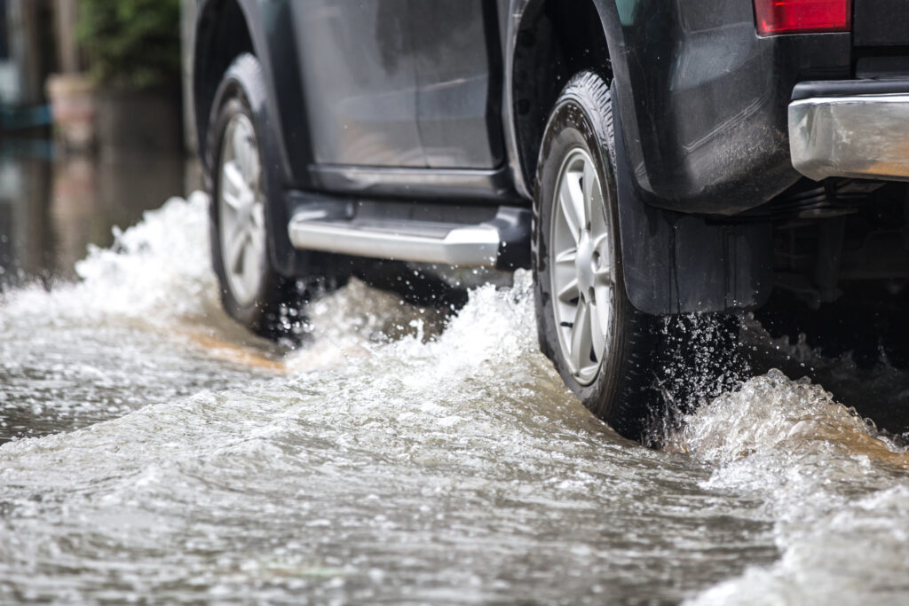 tires driving on flooded street