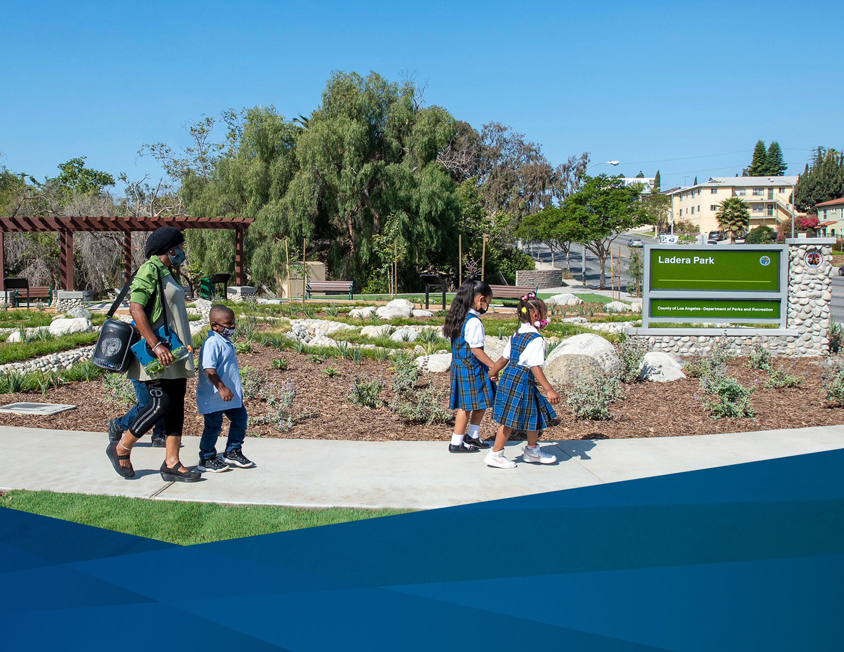 Students and a parent walking through Ladera Park