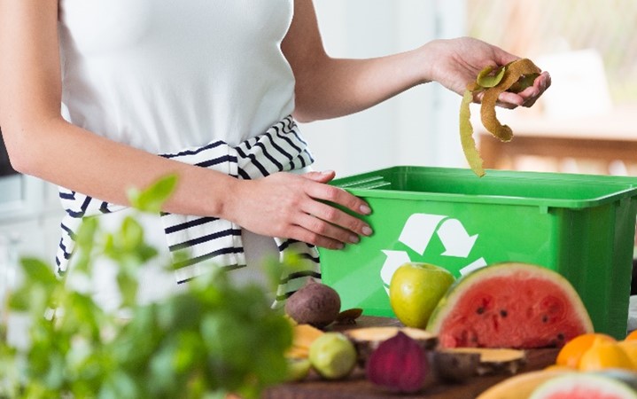 Person placing waste into bin.