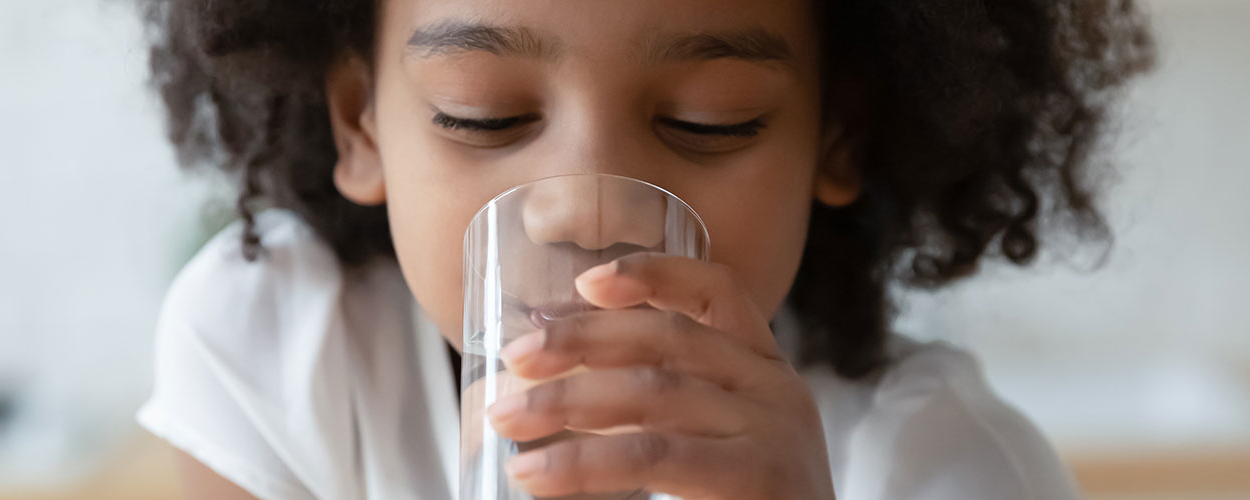 Photo of a girl drinking clean water